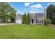 Charming home features a well-manicured lawn and an attached three car garage at 3020 Meadow Glen Pass, Fairburn, GA 30213