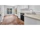 Bright kitchen features black appliances and view of the dining area at 3020 Meadow Glen Pass, Fairburn, GA 30213