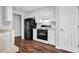 Kitchen featuring white cabinets and black appliances at 3020 Meadow Glen Pass, Fairburn, GA 30213