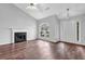 Bright living room features a cozy fireplace, large window, and hardwood floors at 3020 Meadow Glen Pass, Fairburn, GA 30213