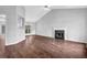 Open-concept living room with hardwood floors and fireplace at 3020 Meadow Glen Pass, Fairburn, GA 30213