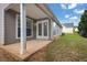 Back patio with siding and a grassy yard at 3020 Meadow Glen Pass, Fairburn, GA 30213