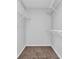 A neutral walk-in closet with carpet and built-in shelving at 3020 Meadow Glen Pass, Fairburn, GA 30213