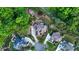 Aerial view of a luxury homes with lush landscaping, circular driveways and mature trees at 3302 Anna Ruby Ln, Buford, GA 30519