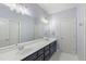 Modern bathroom showcasing a double vanity, large mirror, and updated fixtures at 3302 Anna Ruby Ln, Buford, GA 30519