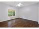 Bedroom with window overlooking the backyard and hardwood floors at 3302 Anna Ruby Ln, Buford, GA 30519