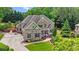 Charming two-story home with brick and stone accents, a well-manicured lawn, and colorful flowerbeds at 3302 Anna Ruby Ln, Buford, GA 30519