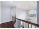 Elegant hallway with a modern chandelier and hardwood floors at 3302 Anna Ruby Ln, Buford, GA 30519