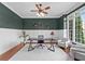 Stylish home office with dark green walls, white wainscoting, and a large window with natural light at 3302 Anna Ruby Ln, Buford, GA 30519
