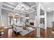 Spacious living room featuring coffered ceilings, built-in shelving, and a stone fireplace at 3302 Anna Ruby Ln, Buford, GA 30519