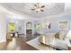 Spacious main bedroom featuring a fireplace, hardwood floors, and a tray ceiling at 3302 Anna Ruby Ln, Buford, GA 30519