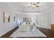 Spacious main bedroom with tray ceiling, large windows, hardwood floors, and a decorative area rug at 3302 Anna Ruby Ln, Buford, GA 30519