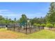 Community playground with modern equipment, surrounded by green space at 3302 Anna Ruby Ln, Buford, GA 30519