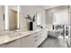 A luxurious bathroom with modern fixtures, double vanity, large soaking tub and bright natural light at 40 12Th Ne St # 1406, Atlanta, GA 30309