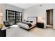 A modern, bright bedroom with a comfortable bed, city views, and stylish furnishings at 40 12Th Ne St # 1406, Atlanta, GA 30309