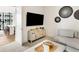 Modern living room with wall-mounted TV, stylish decor, and comfortable seating area with an open doorway at 40 12Th Ne St # 1406, Atlanta, GA 30309
