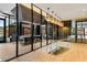 This elegant lobby features a curved staircase, glass walls, and modern light fixtures for an opulent feel at 40 12Th Ne St # 1406, Atlanta, GA 30309