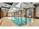 Indoor pool with lounge chairs and floor to ceiling windows at 40 12Th Ne St # 1406, Atlanta, GA 30309