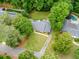 Aerial view showcases a home with an expansive yard, pool, and lush surrounding trees at 4708 Tall Pines Nw Dr, Atlanta, GA 30327