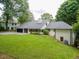 Spacious backyard with lush lawn and mature trees, offering privacy and a peaceful setting at 4708 Tall Pines Nw Dr, Atlanta, GA 30327