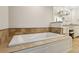 Bathroom featuring a soaking tub with tile surround and granite vanity at 4708 Tall Pines Nw Dr, Atlanta, GA 30327