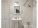 This bathroom features a combination shower and tub with all white tile and a pedestal sink at 4708 Tall Pines Nw Dr, Atlanta, GA 30327