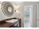 This bathroom features a single sink vanity with dark cabinets, decoractive mirror, and bright lighting at 4708 Tall Pines Nw Dr, Atlanta, GA 30327