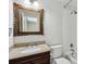 Bathroom with granite countertop, dark wood vanity, and framed mirror at 4708 Tall Pines Nw Dr, Atlanta, GA 30327