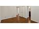 This bedroom features gleaming hardwood floors and has an adjacent hallway with closet storage space at 4708 Tall Pines Nw Dr, Atlanta, GA 30327