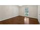 This bedroom features gleaming hardwood floors, bright light, and a modern light fixture at 4708 Tall Pines Nw Dr, Atlanta, GA 30327