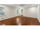 Spacious bedroom featuring hardwood floors, ceiling fan, and ample natural light at 4708 Tall Pines Nw Dr, Atlanta, GA 30327