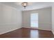 Bedroom with hardwood floors, neutral paint and updated light fixture and window with wood blinds at 4708 Tall Pines Nw Dr, Atlanta, GA 30327