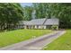 Ranch style home with a well-manicured lawn and a long driveway at 4708 Tall Pines Nw Dr, Atlanta, GA 30327