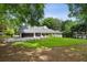 Beautiful single-story home surrounded by mature trees, with a long driveway leading to the garage at 4708 Tall Pines Nw Dr, Atlanta, GA 30327