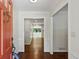 Inviting foyer with hardwood floors, white trim and an orange door leading to the rest of the home at 4708 Tall Pines Nw Dr, Atlanta, GA 30327