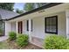 Charming front porch with stone tiling, gray pillars, and a bright red front door at 4708 Tall Pines Nw Dr, Atlanta, GA 30327