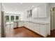 Modern kitchen with white cabinets, stainless steel appliances, and hardwood floors at 4708 Tall Pines Nw Dr, Atlanta, GA 30327