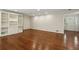 Open living room with hardwood floors, white built in shelving and neutral paint and trim at 4708 Tall Pines Nw Dr, Atlanta, GA 30327
