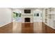 Open living room with fireplace, built in shelving and hardwood floors throughout at 4708 Tall Pines Nw Dr, Atlanta, GA 30327