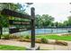 Sign to Chastain Tennis Center with view of tennis courts, landscaping, and greenery, promotes an active lifestyle at 4708 Tall Pines Nw Dr, Atlanta, GA 30327