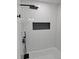 Modern bathroom featuring black fixtures, herringbone tiling, and a tiled shower niche at 775 Lee Andrews Se Ave, Atlanta, GA 30315