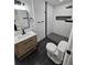 Modern bathroom with a herringbone tile shower, stylish vanity, and black accents at 775 Lee Andrews Se Ave, Atlanta, GA 30315