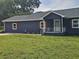 Charming home with dark blue siding, a white porch, and a well-manicured lawn at 775 Lee Andrews Se Ave, Atlanta, GA 30315