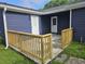 Dark blue home featuring a wooden railing and white doors at 775 Lee Andrews Se Ave, Atlanta, GA 30315