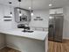 Well-lit kitchen featuring stainless steel appliances, a breakfast bar, and modern pendant lighting at 775 Lee Andrews Se Ave, Atlanta, GA 30315
