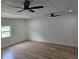 Bright living room with hardwood floors, two ceiling fans, and natural light from the window at 775 Lee Andrews Se Ave, Atlanta, GA 30315