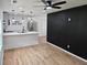 Open-concept living area featuring hardwood floors, a modern ceiling fan, and an adjacent kitchen at 775 Lee Andrews Se Ave, Atlanta, GA 30315