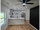 Bright and airy living area with hardwood floors, modern lighting, and an open layout to the kitchen at 775 Lee Andrews Se Ave, Atlanta, GA 30315