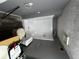 The bathroom is being remodeled and features a new shower stall and toilet in a gray-toned room at 1310 Muirforest Way, Stone Mountain, GA 30088