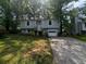 Charming two-story home with a well-maintained front yard and a one car garage and a driveway at 1310 Muirforest Way, Stone Mountain, GA 30088